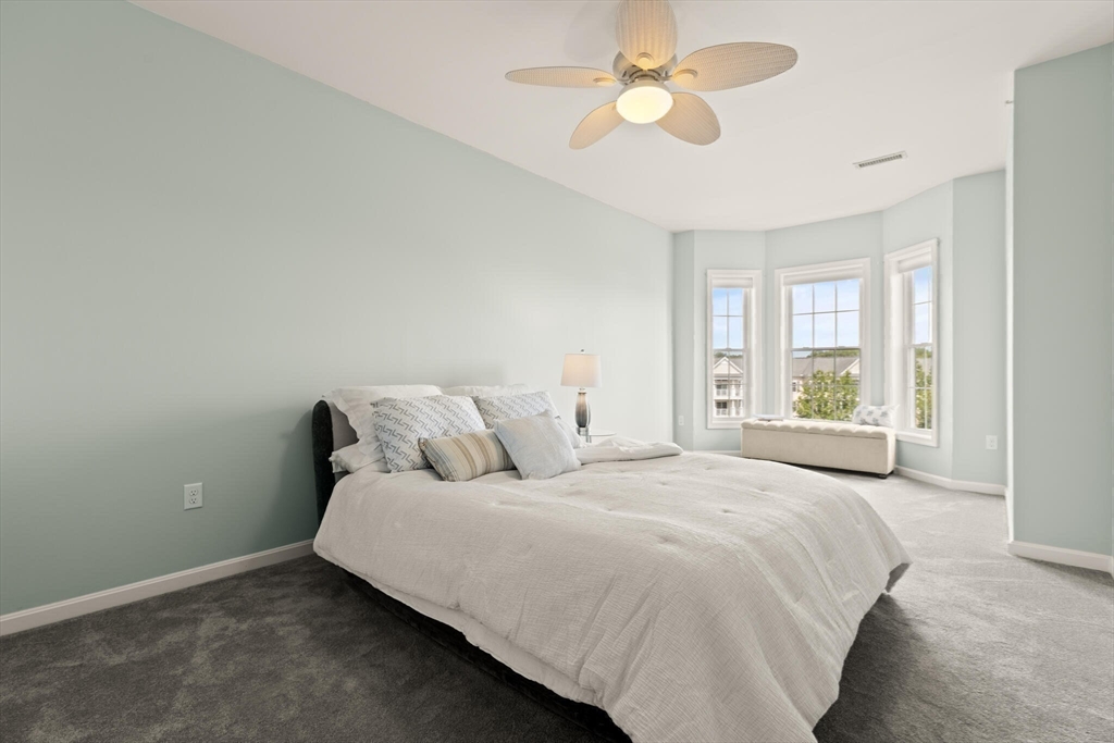 418 John Mahar Highway, Unit 408 Braintree, MA 02184 - Photo 12 of 35 a large bed sitting in a bedroom next to a window