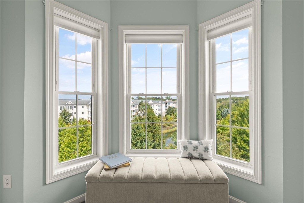 418 John Mahar Highway, Unit 408 Braintree, MA 02184 - Photo 13 of 35 a bed sitting in front of a window next to a window