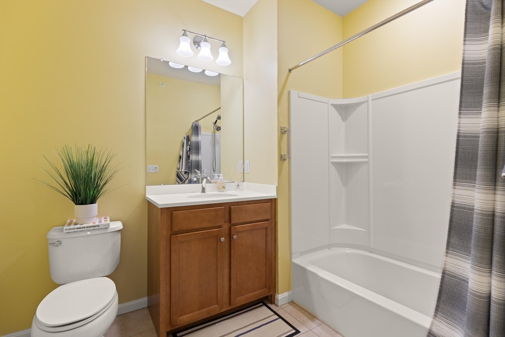 418 John Mahar Highway, Unit 408 Braintree, MA 02184 - Photo 19 of 35 a bathroom with a sink a toilet a mirror and shower