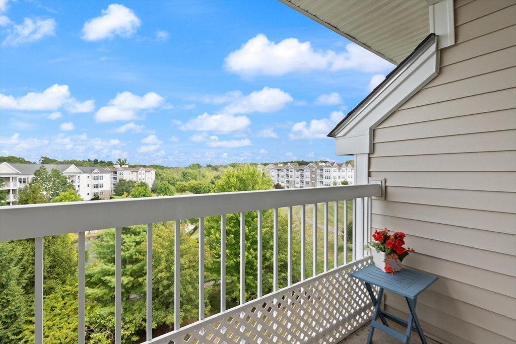 418 John Mahar Highway, Unit 408 Braintree, MA 02184 - Photo 20 of 35 a view of a porch with furniture and wooden floor