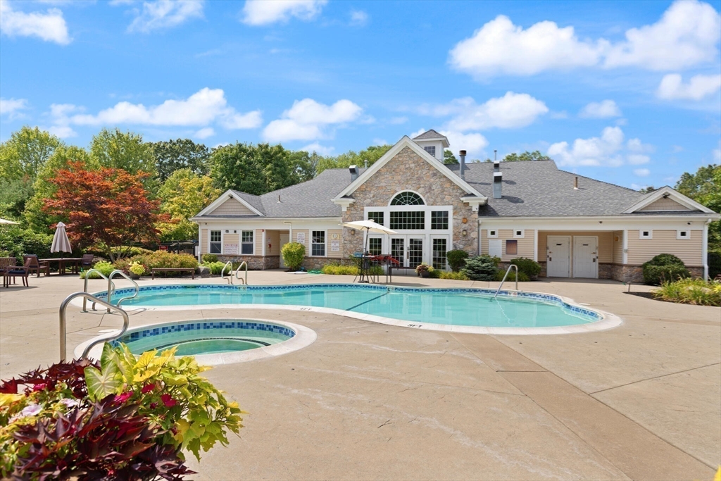 418 John Mahar Highway, Unit 408 Braintree, MA 02184 - Photo 23 of 35 a front view of a house with a big yard and potted plants