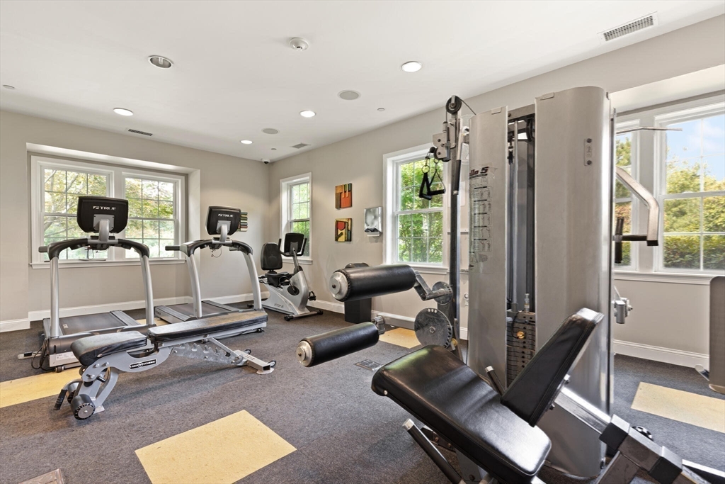 418 John Mahar Highway, Unit 408 Braintree, MA 02184 - Photo 24 of 35 a room with gym equipment and a large window