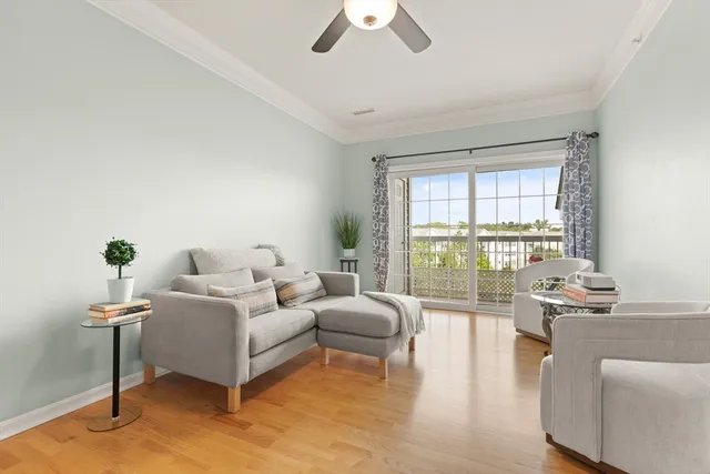 a dining room with furniture a chandelier and wooden floor