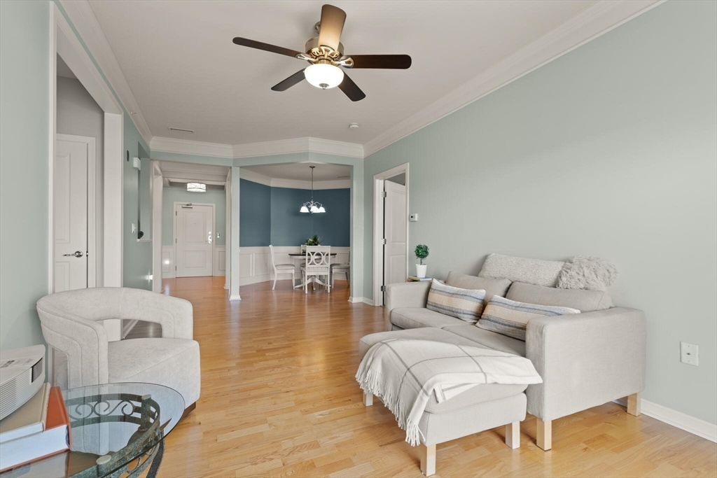 418 John Mahar Highway, Unit 408 Braintree, MA 02184 - Photo 7 of 35 a living room with furniture and a chandelier