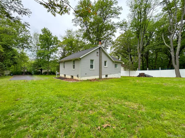 a view of a backyard with large trees