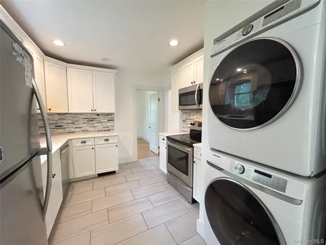 a kitchen with a stove top oven and cabinets