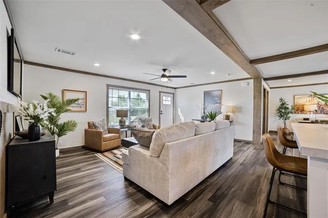 a living room with furniture and a wooden floor