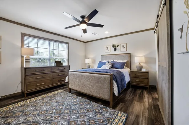 a bedroom with a bed and a large window