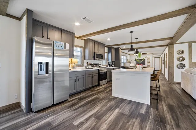 a kitchen with refrigerator cabinets and wooden floor