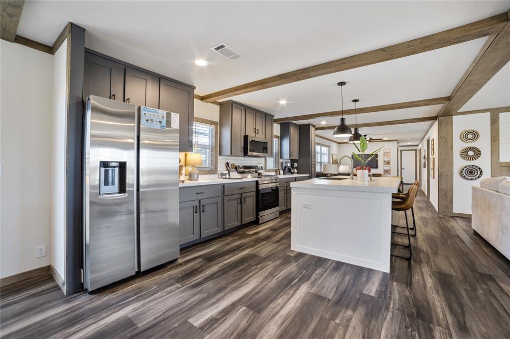 2004 Buffet Way Poolville, TX 76487 - Photo 2 of 36 a kitchen with refrigerator cabinets and wooden floor