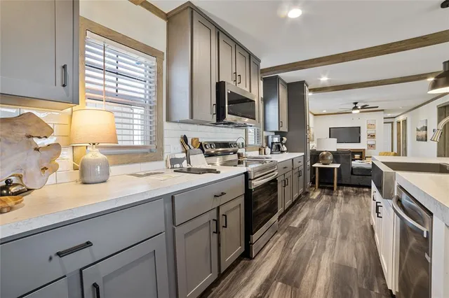 a kitchen with a sink stove top oven and cabinets