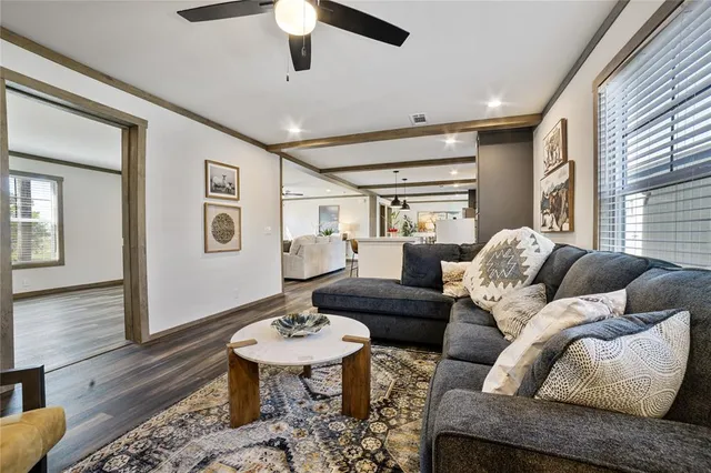 a living room with furniture and wooden floor