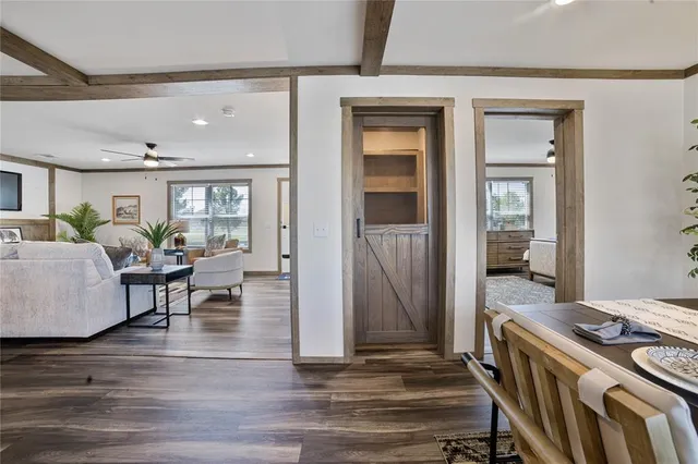 a living room with furniture and wooden floor