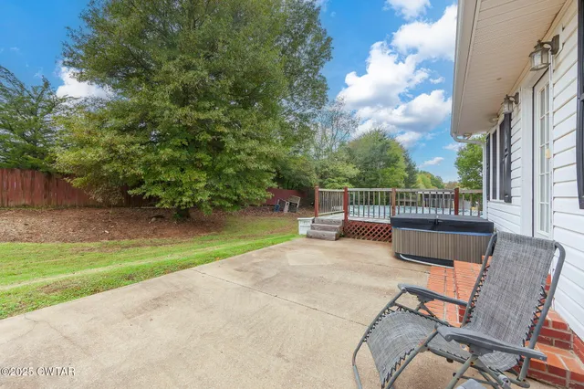 a view of a chairs and table in the backyard