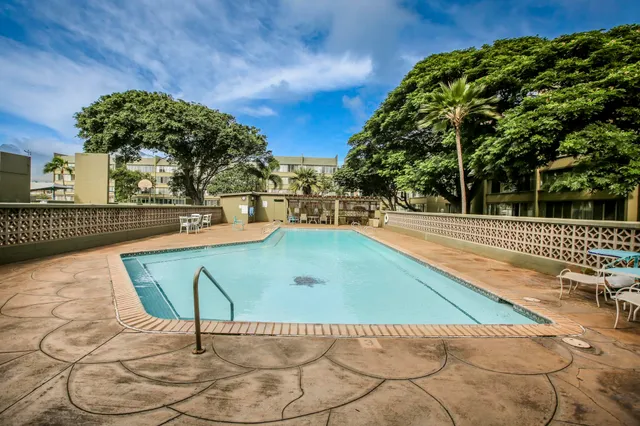 a view of a field with of trees in the background