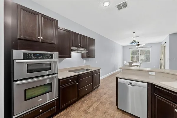 a kitchen with sink stove and microwave
