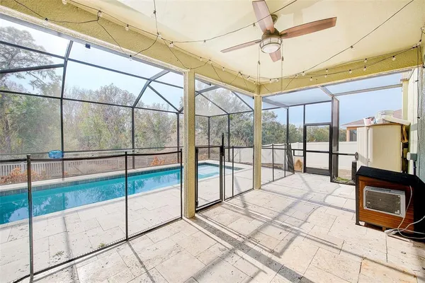 a swimming pool with large glass windows and painted walls