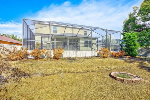 an aerial view of a house with yard and outdoor seating