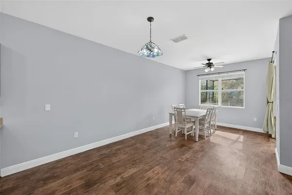 an empty room with windows and furniture