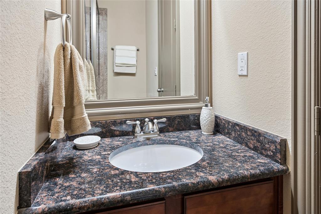835 Rockingham Drive Irving, TX 75063 - Photo 11 of 27 a bathroom with a granite countertop sink and a mirror