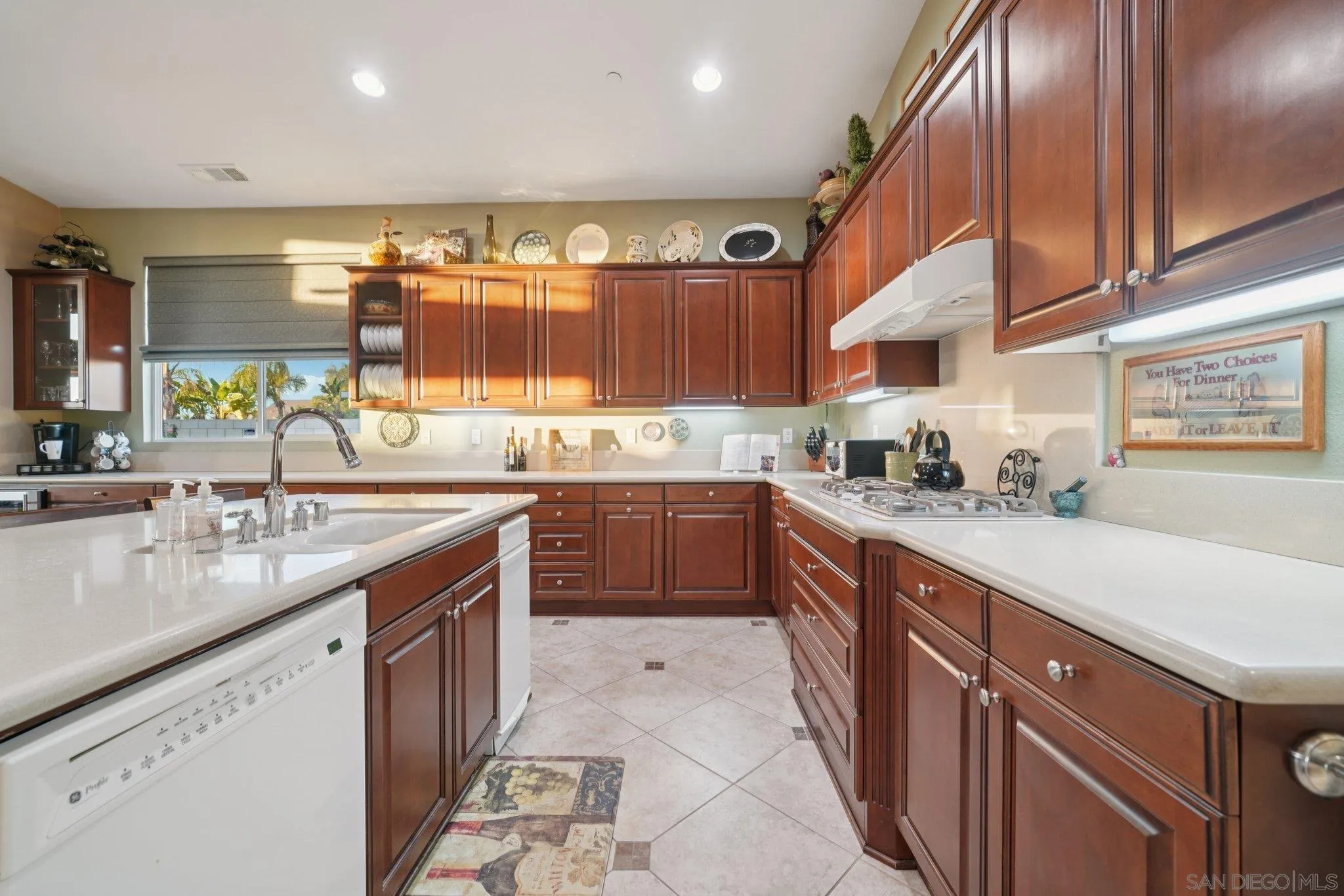 9471 Estrella Hills Street Riverside, CA 92508 - Photo 12 of 43 a kitchen with stainless steel appliances granite countertop a sink counter space cabinets and a large window