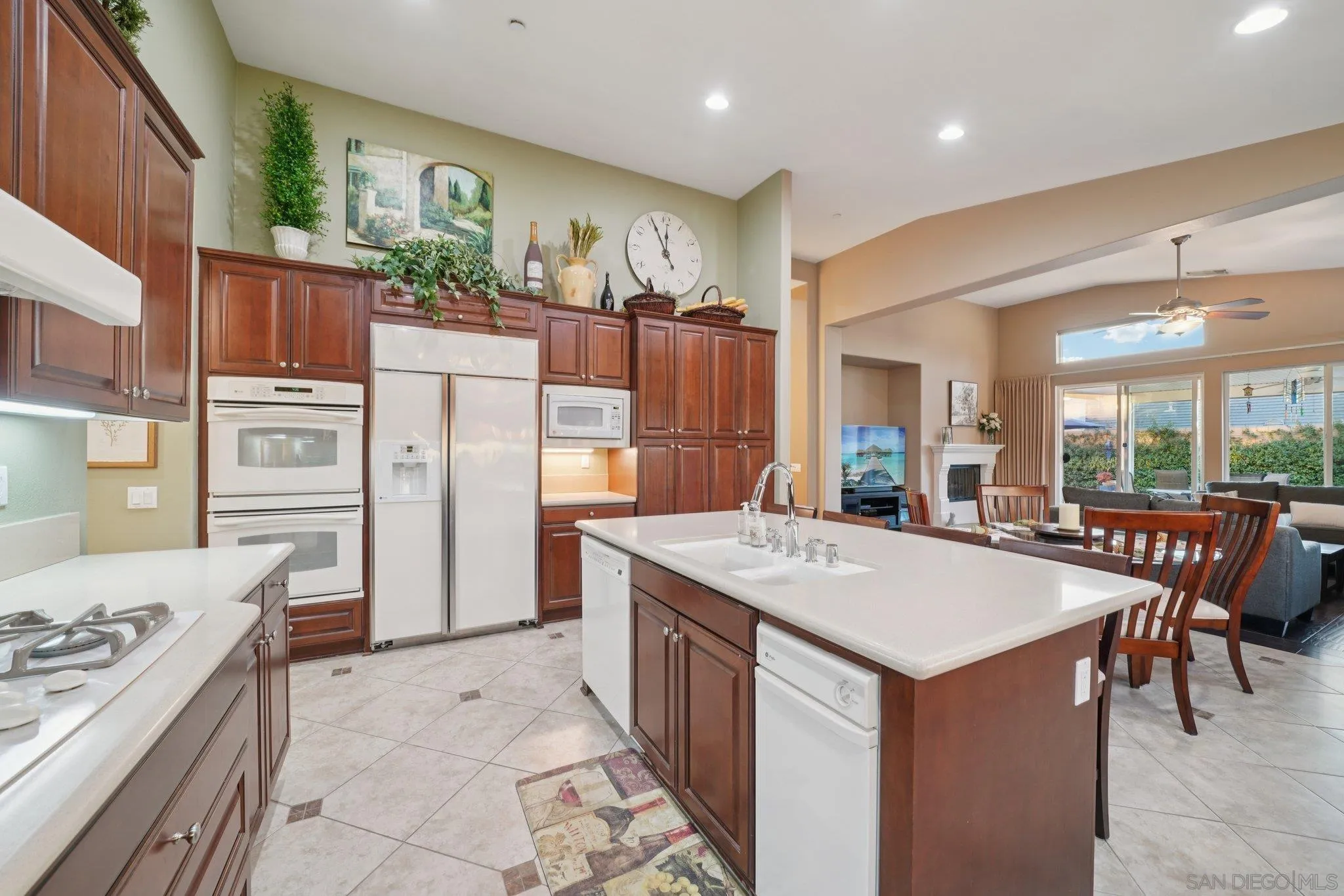 9471 Estrella Hills Street Riverside, CA 92508 - Photo 14 of 43 a kitchen that has a lot of cabinets a sink and a stove in it