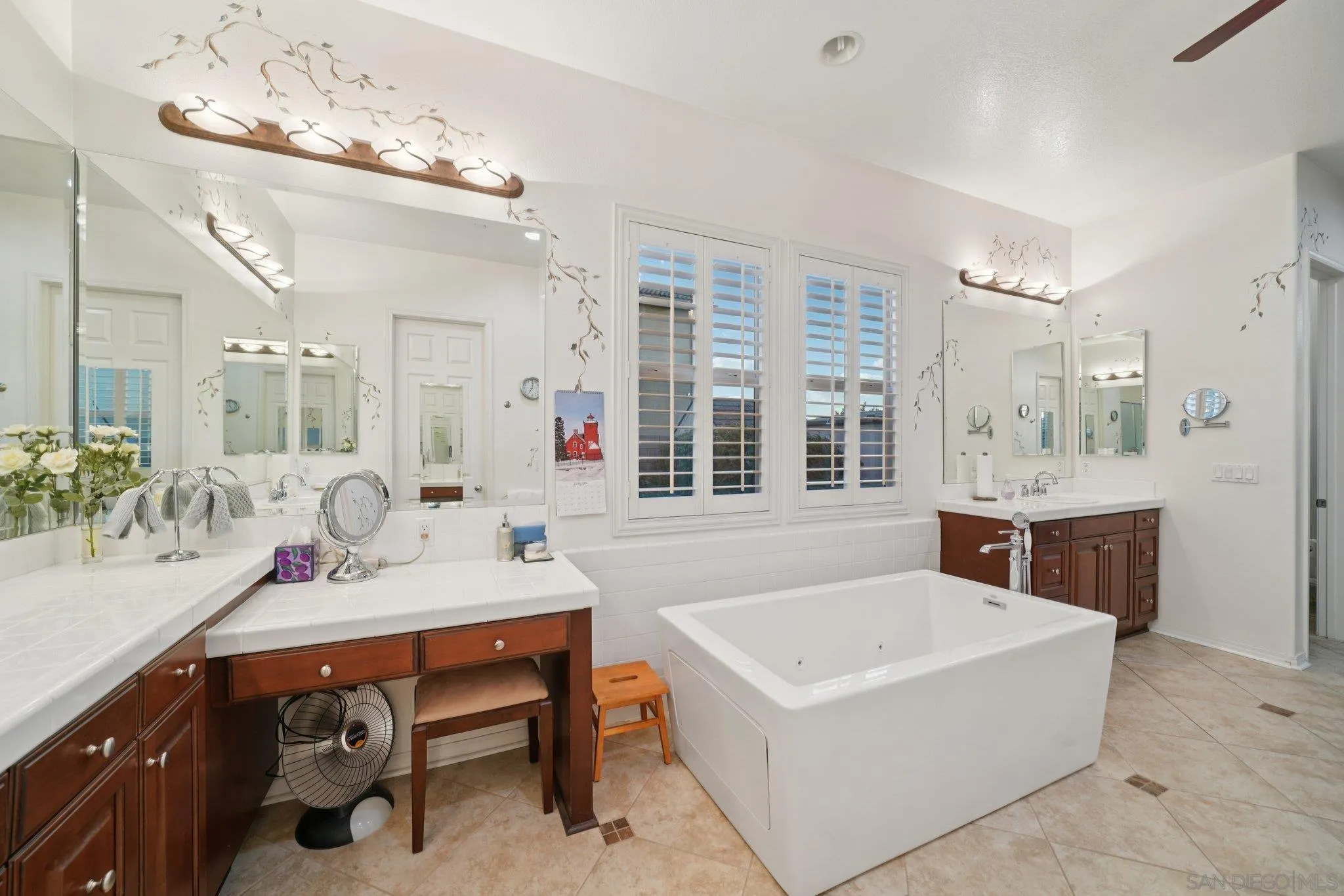9471 Estrella Hills Street Riverside, CA 92508 - Photo 17 of 43 a en suite bathroom with a tub sink double vanity and windows