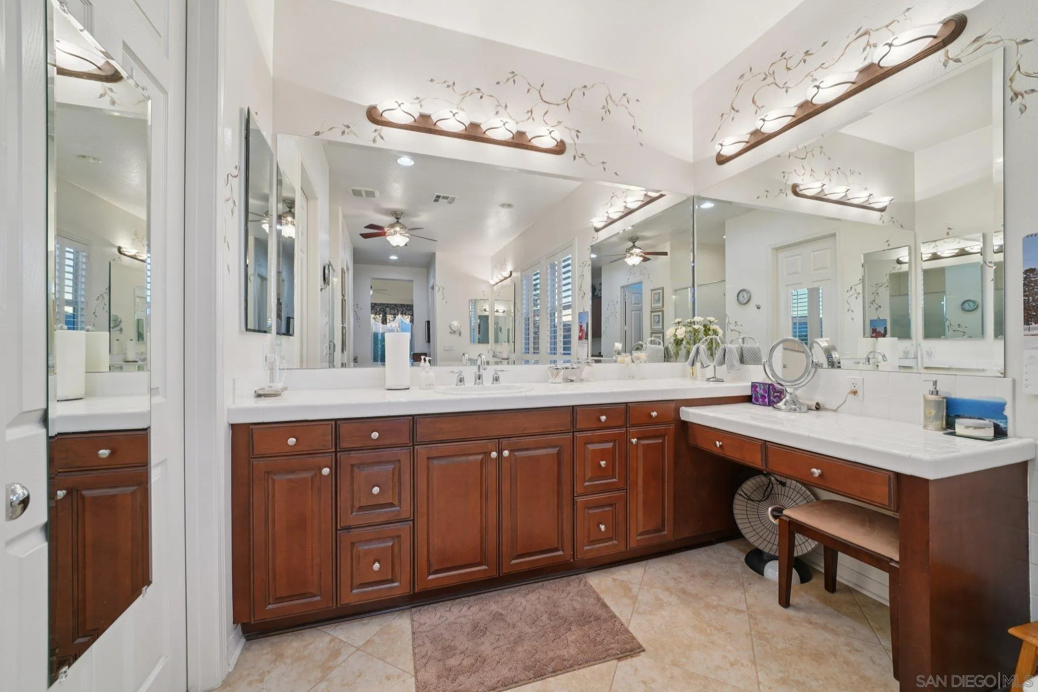 9471 Estrella Hills Street Riverside, CA 92508 - Photo 19 of 43 a spacious bathroom with a sink vanity and a mirror