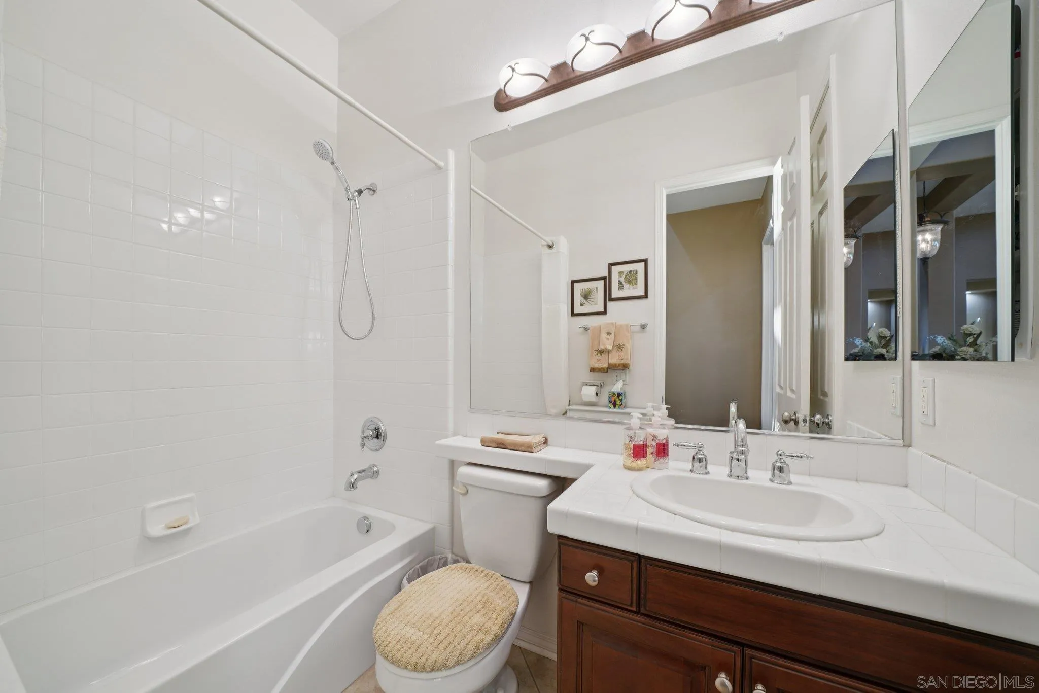 9471 Estrella Hills Street Riverside, CA 92508 - Photo 22 of 43 a bathroom with a sink a toilet a mirror and shower