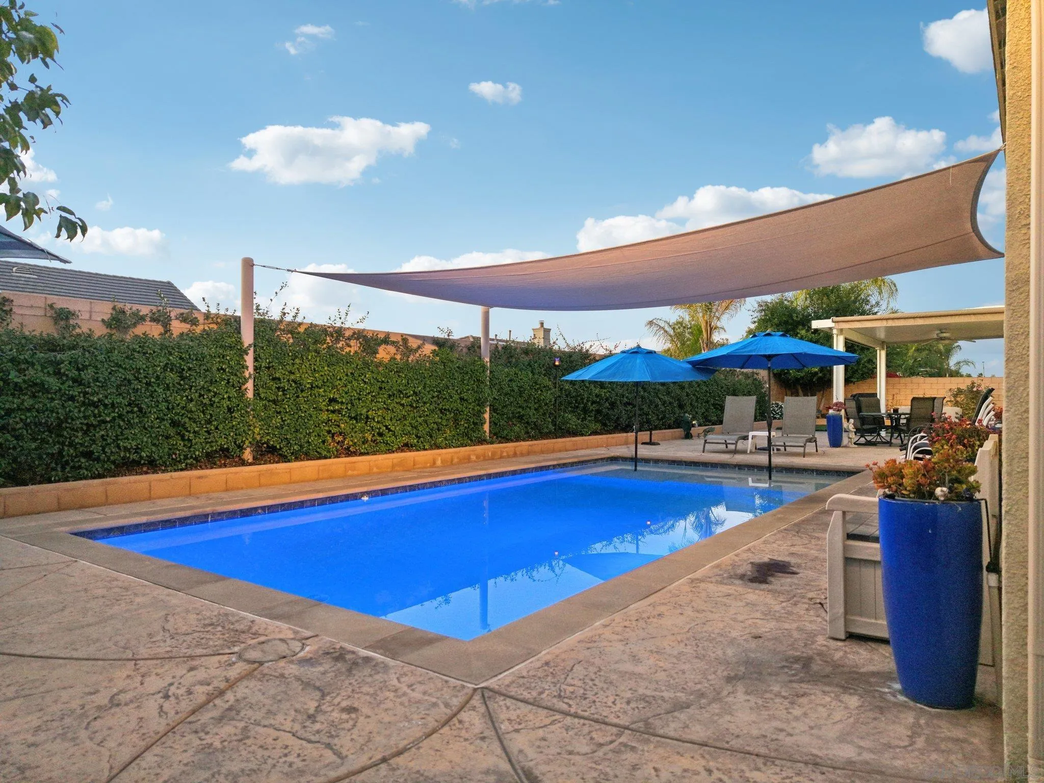 9471 Estrella Hills Street Riverside, CA 92508 - Photo 33 of 43 a view of swimming pool with chairs in patio