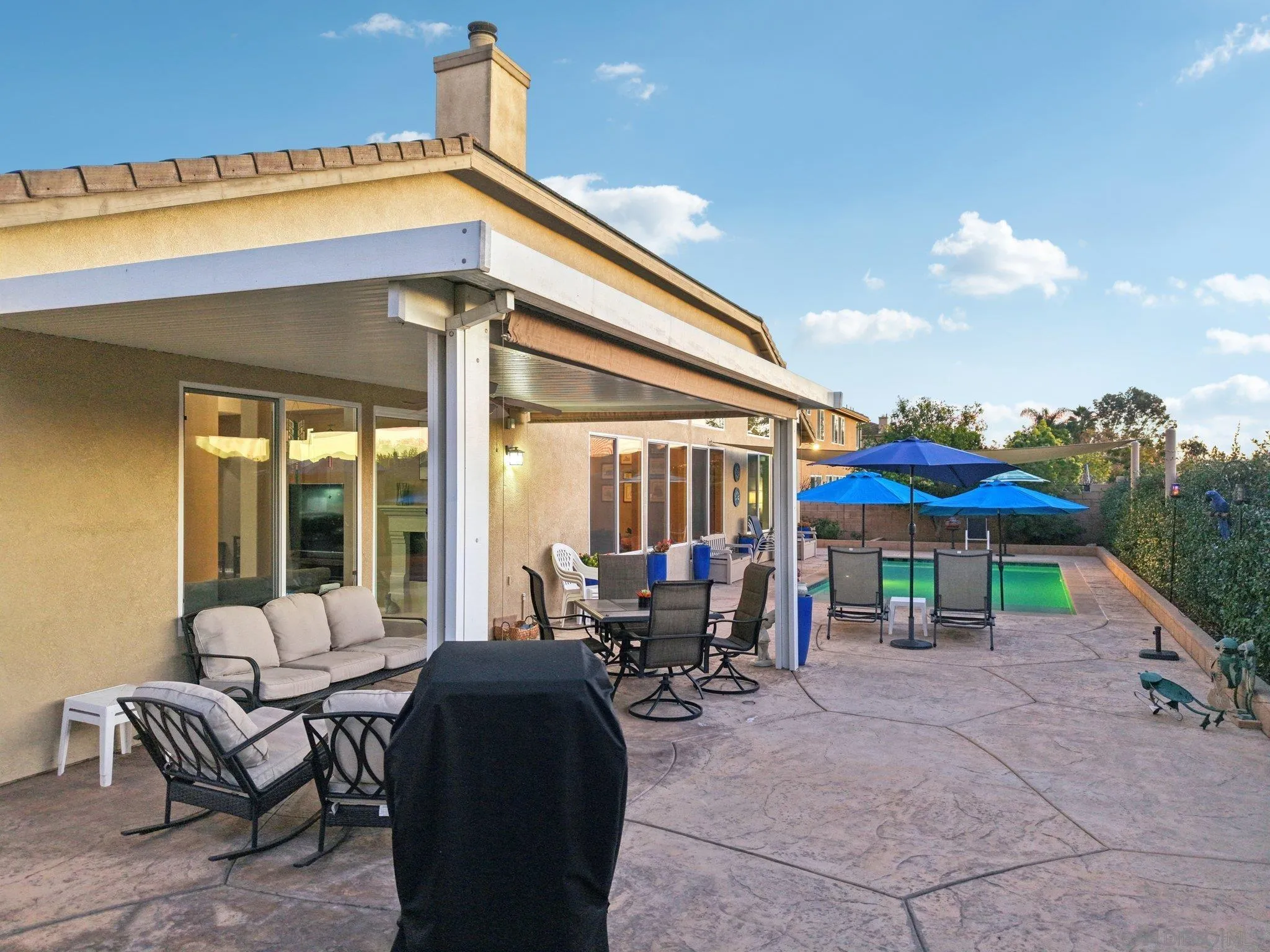 9471 Estrella Hills Street Riverside, CA 92508 - Photo 37 of 43 a patio with a table and chairs under an umbrella