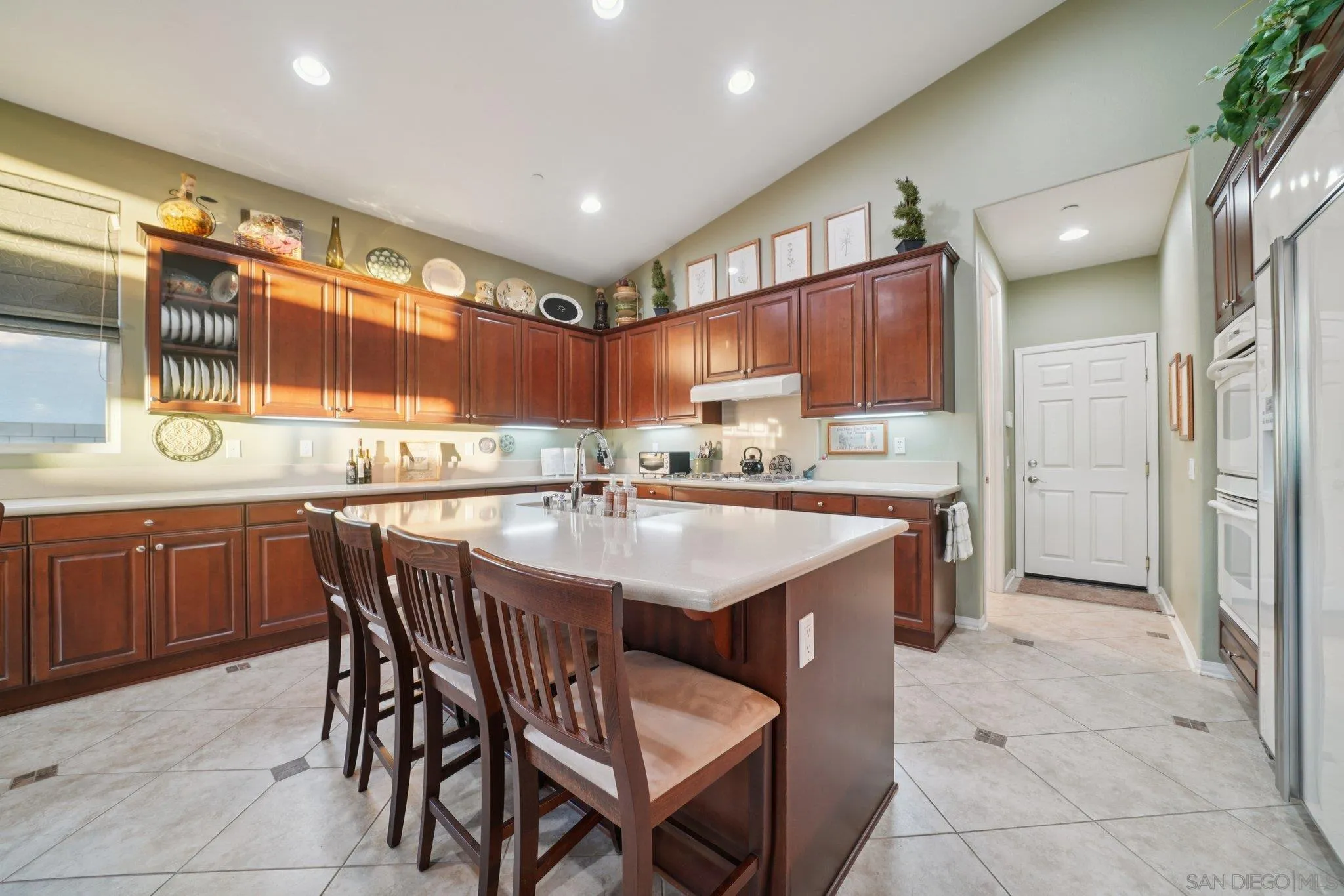 9471 Estrella Hills Street Riverside, CA 92508 - Photo 10 of 43 a kitchen with stainless steel appliances granite countertop a sink and a refrigerator