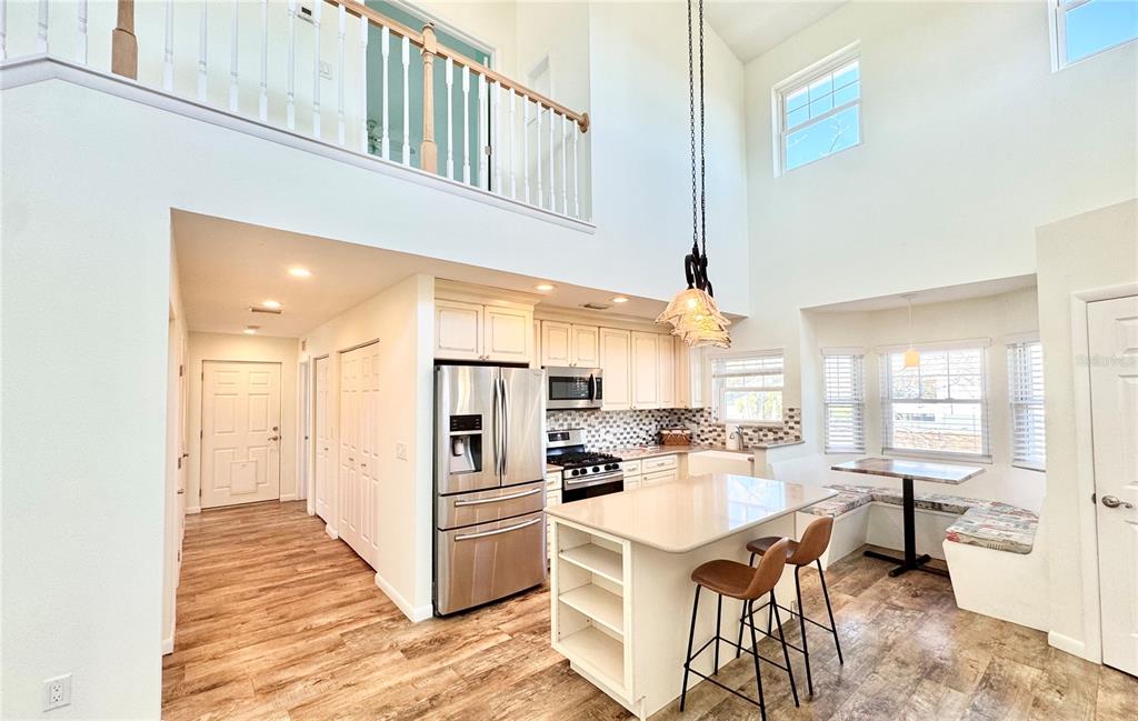 16204 3rd Street East Redington Beach, FL 33708 - Photo 17 of 58 a kitchen with stainless steel appliances kitchen island granite countertop a refrigerator and a sink