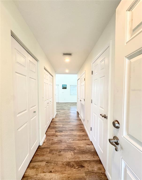 16204 3rd Street East Redington Beach, FL 33708 - Photo 19 of 58 a view of a hallway with wooden floor and staircase
