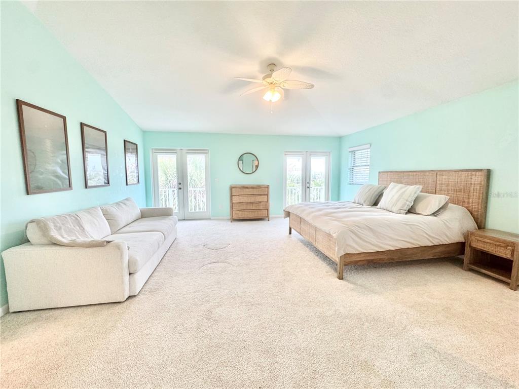 16204 3rd Street East Redington Beach, FL 33708 - Photo 26 of 58 a bedroom with a large bed and a couch