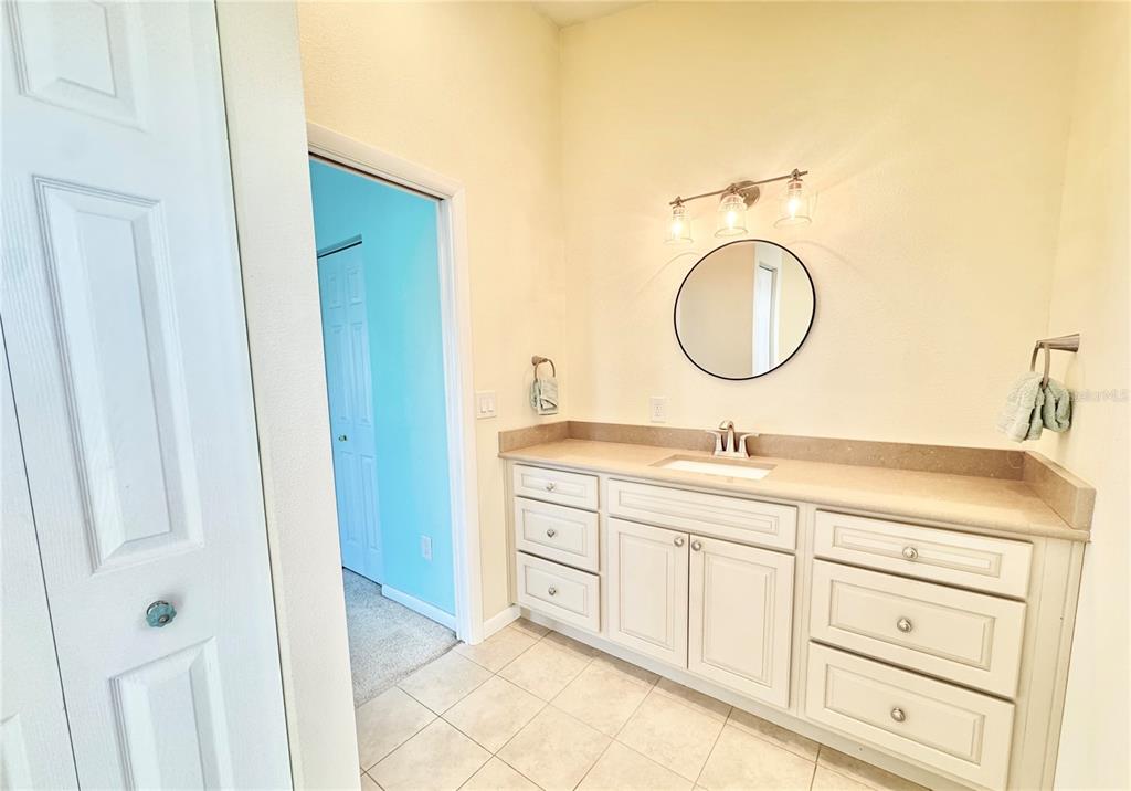 16204 3rd Street East Redington Beach, FL 33708 - Photo 31 of 58 a bathroom with a double vanity sink and a mirror