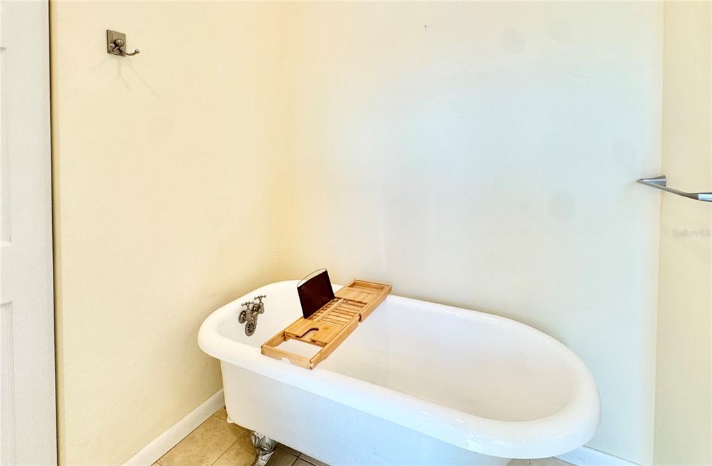16204 3rd Street East Redington Beach, FL 33708 - Photo 34 of 58 a white bath tub sitting in a bathroom
