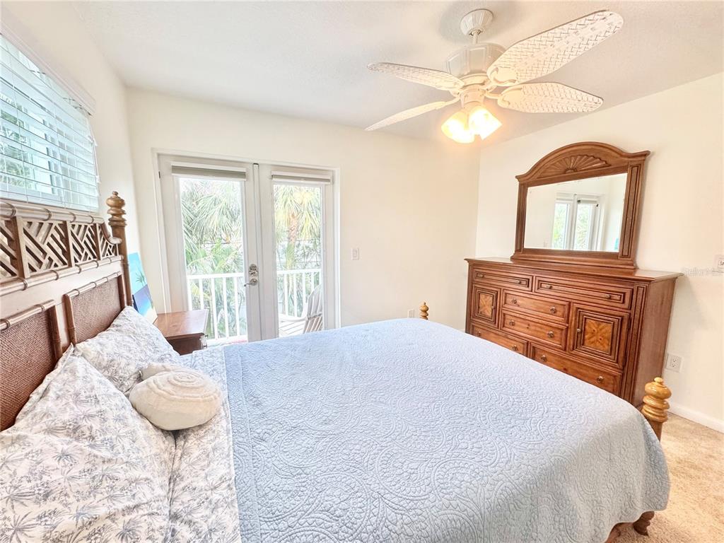 16204 3rd Street East Redington Beach, FL 33708 - Photo 36 of 58 a bedroom with a large bed and a chandelier