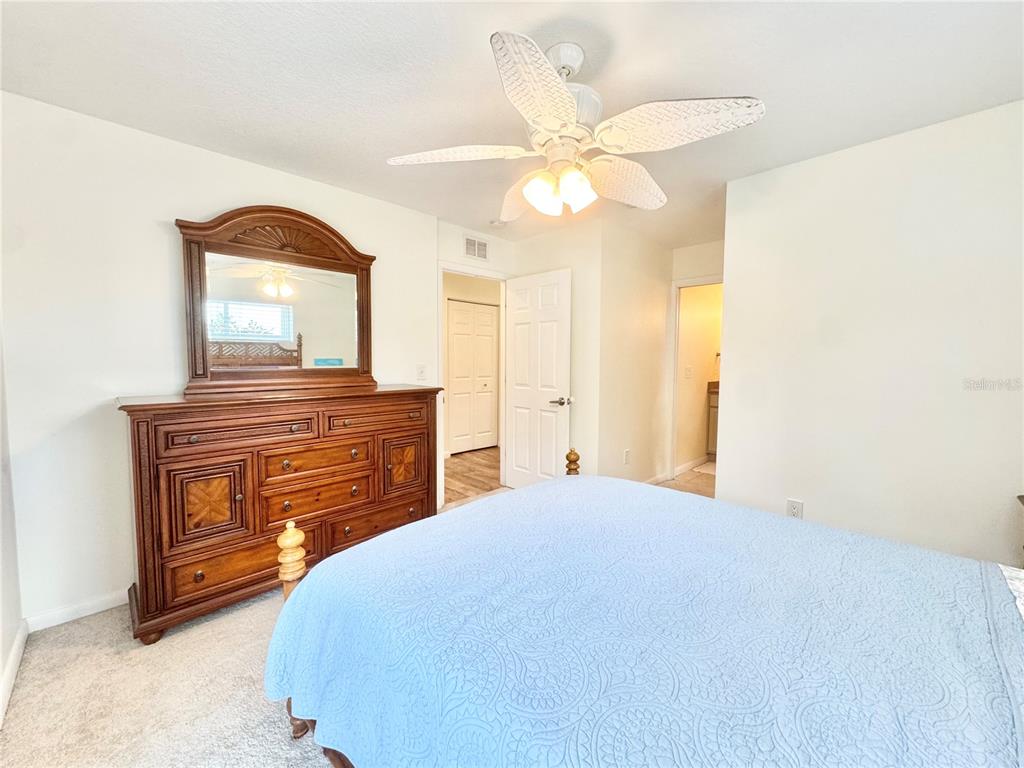 16204 3rd Street East Redington Beach, FL 33708 - Photo 37 of 58 a bedroom with a bed and a chandelier