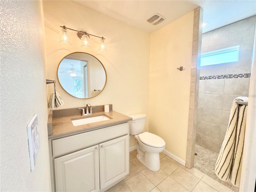 16204 3rd Street East Redington Beach, FL 33708 - Photo 39 of 58 a bathroom with a sink a toilet and a mirror
