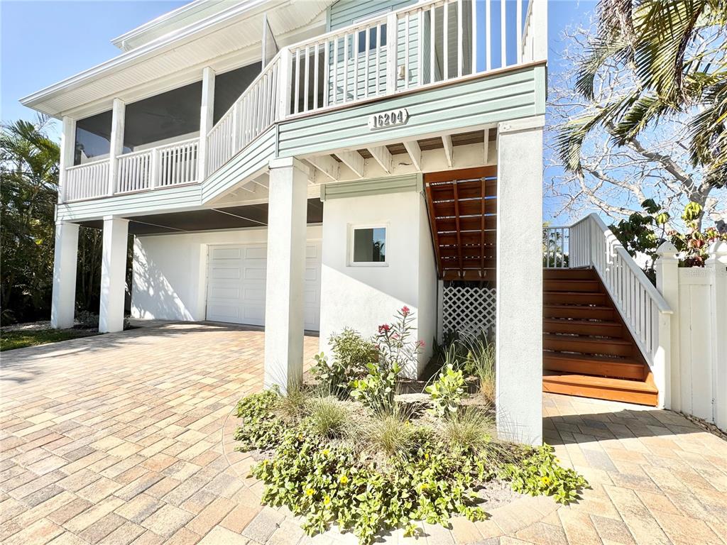 16204 3rd Street East Redington Beach, FL 33708 - Photo 5 of 58 a front view of a house with a yard