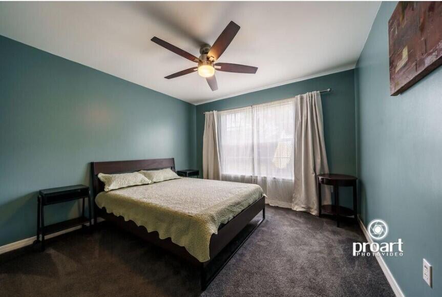 641 Bayshore Drive Destin, FL 32550 - Photo 14 of 34 a bedroom with a bed and a chandelier