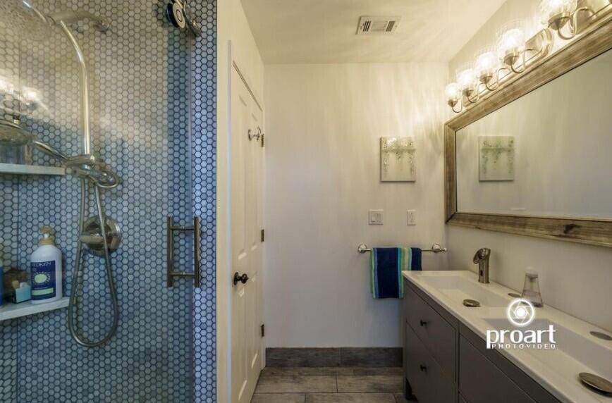 641 Bayshore Drive Destin, FL 32550 - Photo 19 of 34 a bathroom with a sink a toilet and mirror