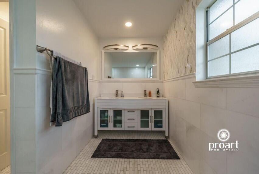 641 Bayshore Drive Destin, FL 32550 - Photo 22 of 34 a bathroom with a sink and a mirror