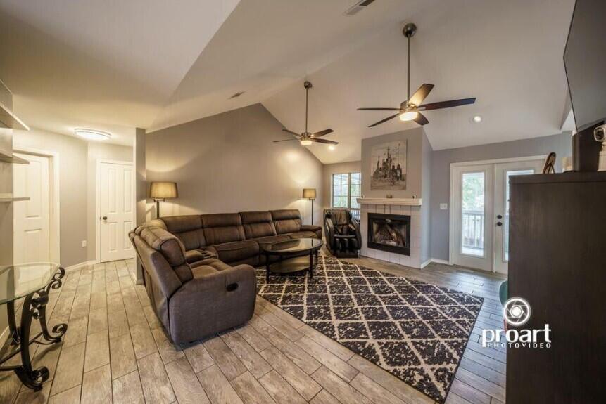 641 Bayshore Drive Destin, FL 32550 - Photo 24 of 34 a living room with furniture a fireplace and a chandelier