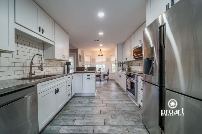 641 Bayshore Drive Destin, FL 32550 - Photo 26 of 34 a large kitchen with stainless steel appliances lots of counter space and a sink