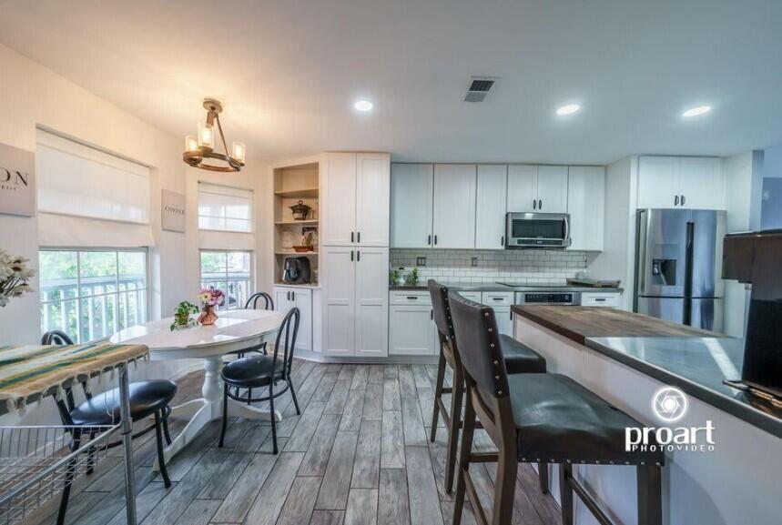 641 Bayshore Drive Destin, FL 32550 - Photo 27 of 34 a kitchen with kitchen island a dining table chairs stainless steel appliances and cabinets