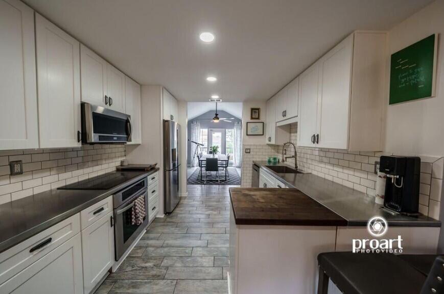641 Bayshore Drive Destin, FL 32550 - Photo 32 of 34 a kitchen with stainless steel appliances granite countertop a sink a stove top oven a counter space and cabinets