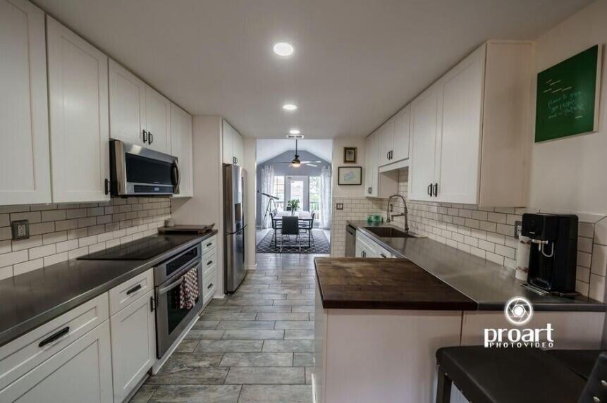 641 Bayshore Drive Destin, FL 32550 - Photo 34 of 34 a large kitchen with stainless steel appliances granite countertop a lot of counter space and a sink