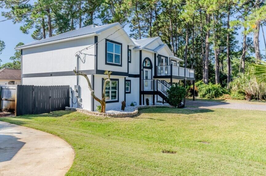 641 Bayshore Drive Destin, FL 32550 - Photo 6 of 34 a view of a house with backyard and sitting area